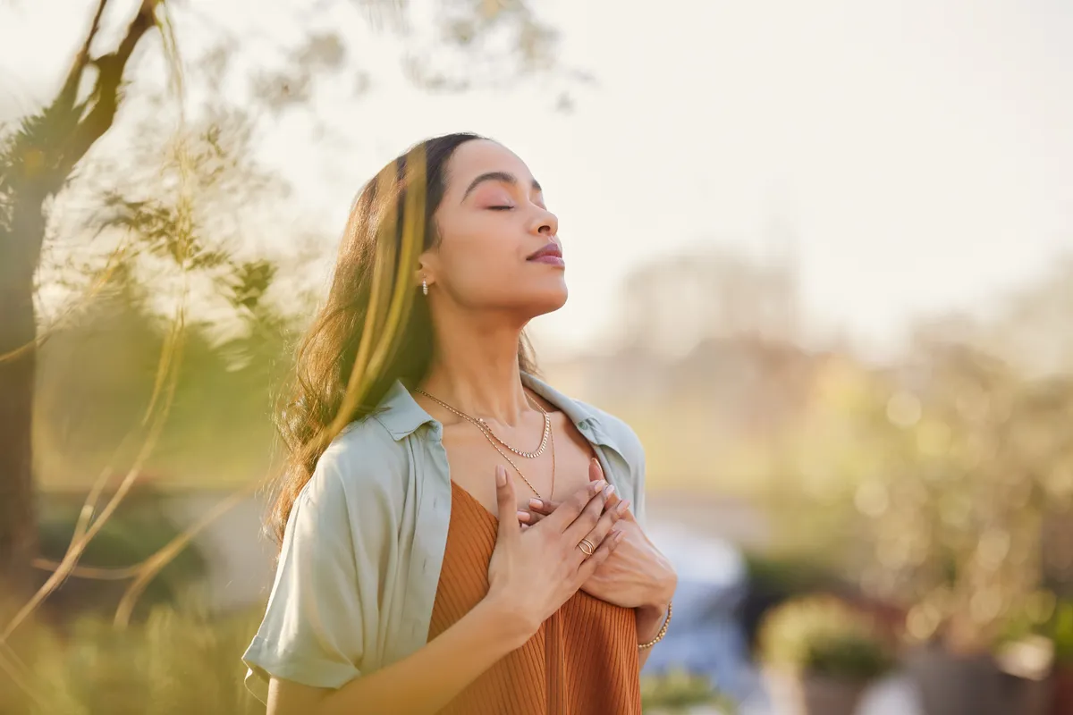 Woman breathing peacefully outdoors