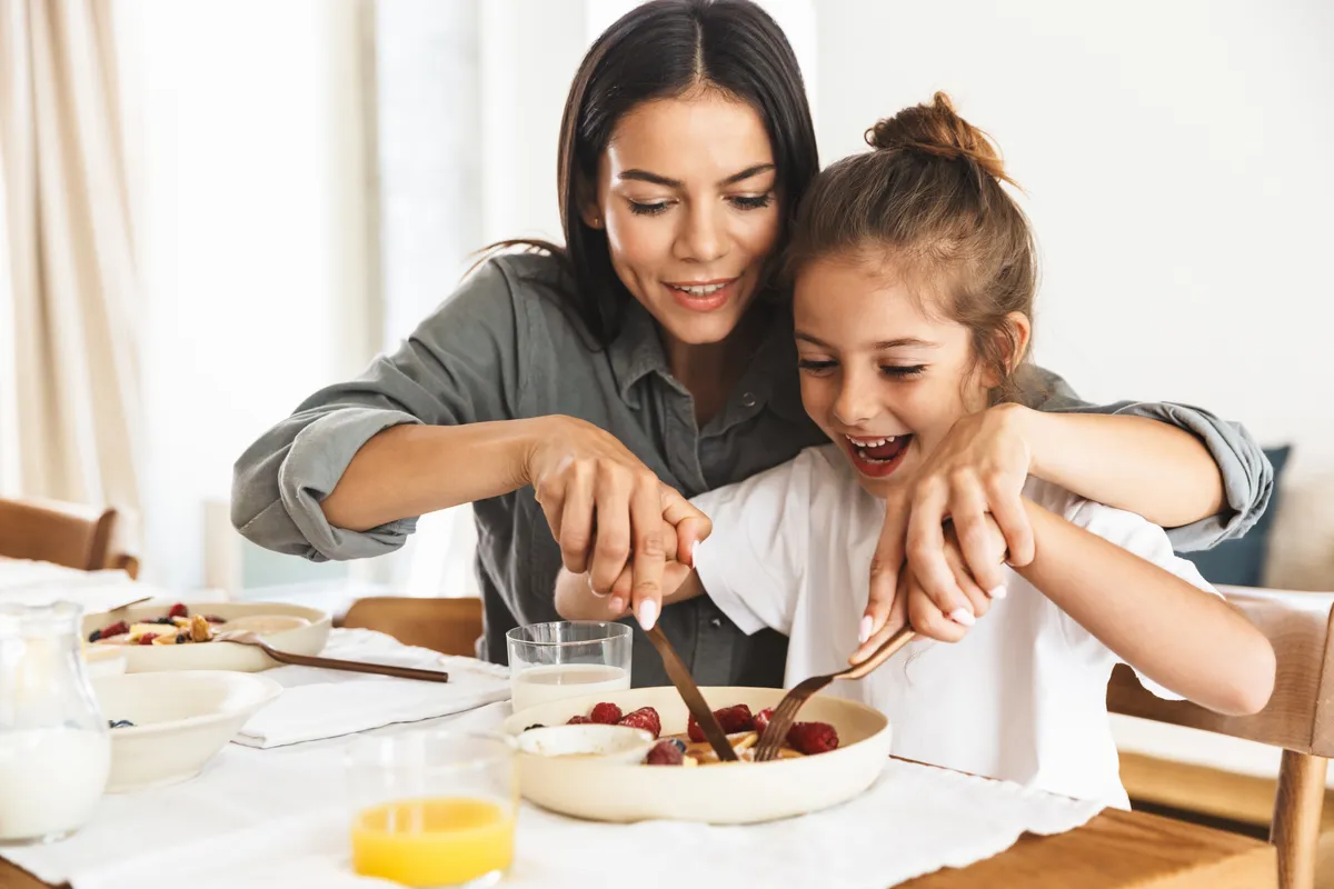 Mother and daughter eating together
