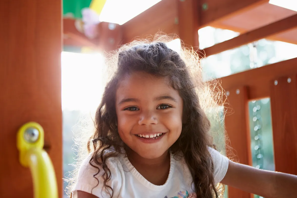 Happy girl smiling on a playground